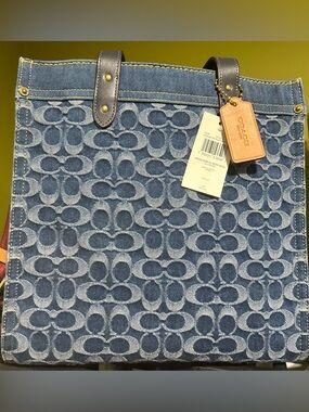 Coach Indigo Navy Signature Denim Tote
Handles are 5.5 . Crossbody strap as well